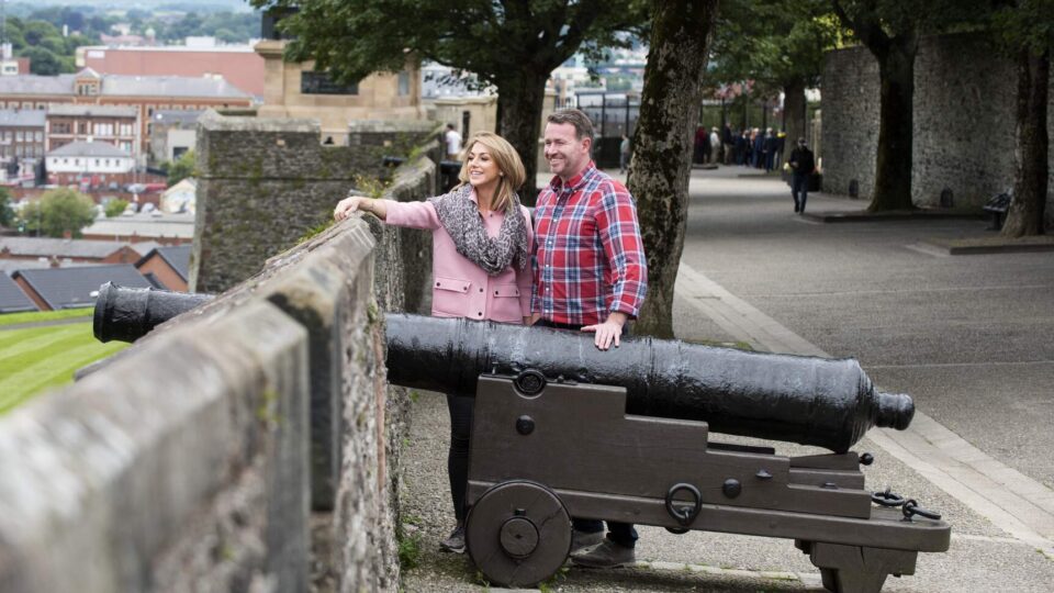 Couple walking on Derry Walls 2_web-size_2500x1200px