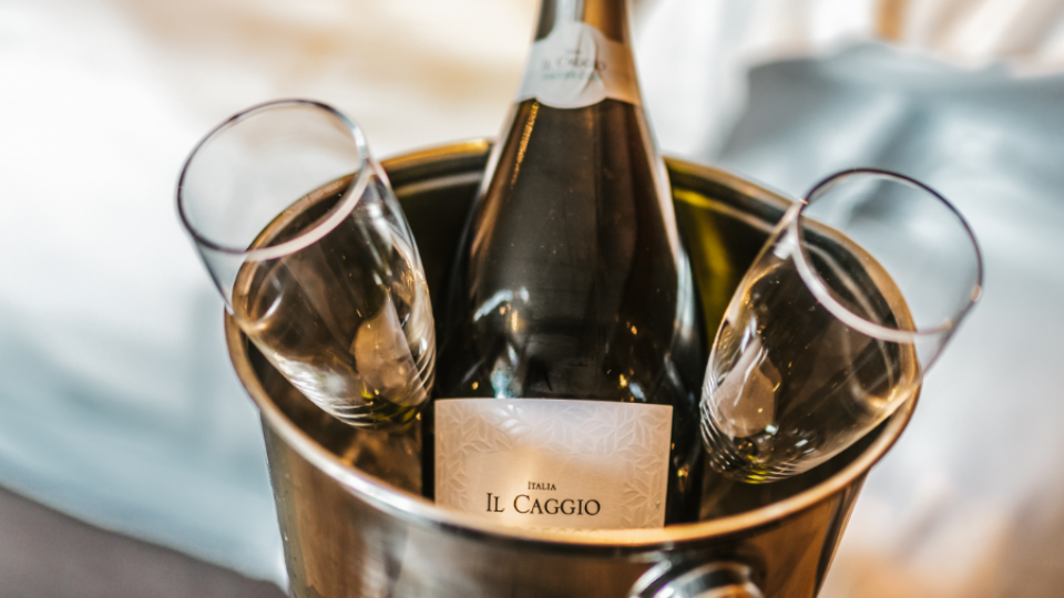 Luxurious hotel room with a bottle of sparkling wine in a silver ice bucket, promising a romantic, indulgent stay.