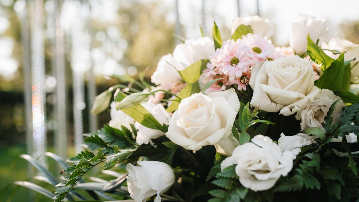 Luxurious hotel garden with blooming roses and daisies, perfect for relaxing or events. Experience nature's beauty.